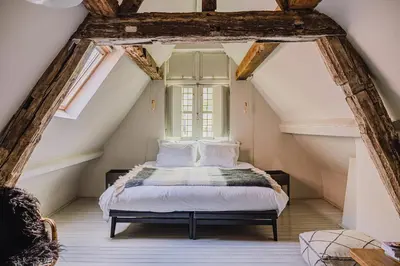 a bedroom with a bed in the attic at Burgstraat 8 in Ghent