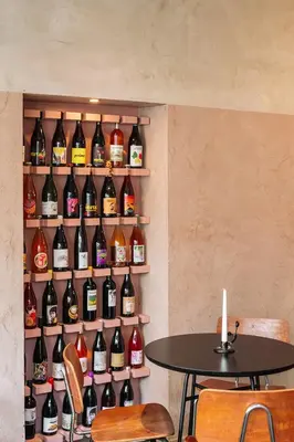 a wall filled with lots of bottles of wine at Burgstraat 8 in Ghent