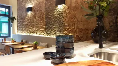 a kitchen counter with a sink and a vase with flowers at Boutique Holiday Home Zalig In Antwerpen in Antwerp