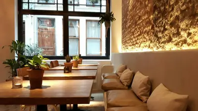 a room with tables and a couch and windows at Boutique Holiday Home Zalig In Antwerpen in Antwerp