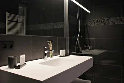 a bathroom with a white sink and a mirror at B&B VIENNA in Lokeren