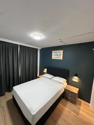 a bedroom with a bed and a blue wall at Hotel Albert in Brussels