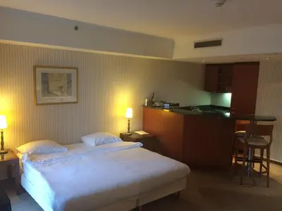 a hotel room with a bed and a kitchen at B-aparthotel Ambiorix in Brussels