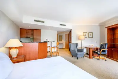 a hotel room with a bed and a kitchen at B-aparthotel Ambiorix in Brussels
