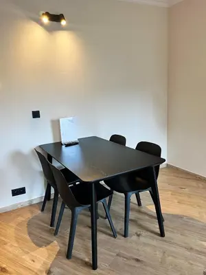 a black table with chairs and a laptop on it at B-aparthotel Ambiorix in Brussels