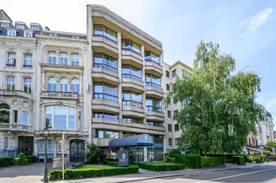 an apartment building on the corner of a street at B-aparthotel Montgomery in Brussels