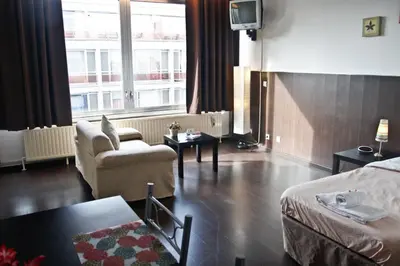 a hotel room with a bed and a living room at Budget Flats Antwerp in Antwerp