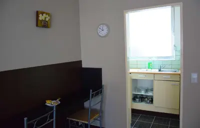 a kitchen with a sink and a clock on the wall at Budget Flats Antwerp in Antwerp
