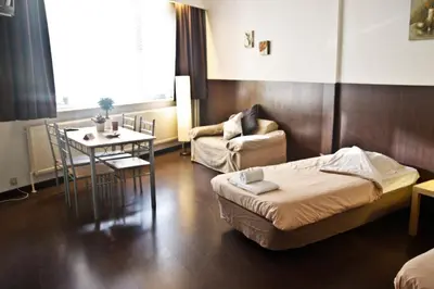 a room with a bed and a table and a chair at Budget Flats Antwerp in Antwerp