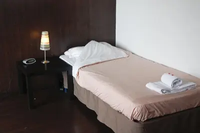 a bedroom with a bed with towels on a table at Budget Flats Antwerp in Antwerp