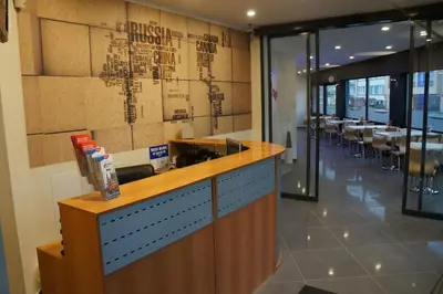 a restaurant with a bar with a map on the wall at Hotel Evergreen in Brussels