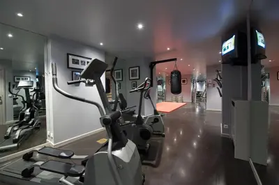 a gym with two exercise bikes and a television at Hotel Manos Premier in Brussels