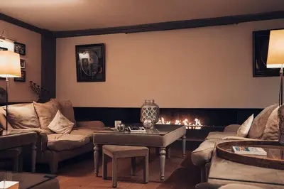 a living room with a couch and a fire place at Hotel Manos Premier in Brussels
