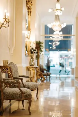 a living room with chairs and a chandelier at Hotel Manos Stephanie in Brussels