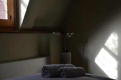 a bedroom with a vase with towels on a bed at B&B De Vrome Vos in Mechelen