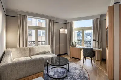 a living room with a couch and a table at Brussels Marriott Hotel Grand Place in Brussels
