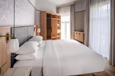 a bedroom with a large white bed with white pillows at Brussels Marriott Hotel Grand Place in Brussels