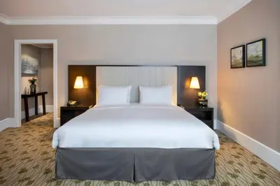 a large white bed in a hotel room at Renaissance Brussels Hotel in Brussels