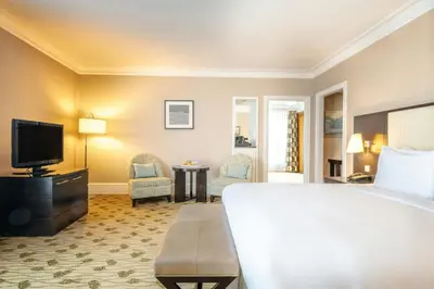 a hotel room with a large bed and a television at Renaissance Brussels Hotel in Brussels