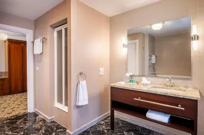 a bathroom with a sink and a mirror at Renaissance Brussels Hotel in Brussels