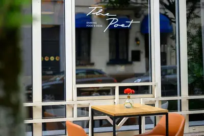 a table with a vase with a flower on it at Renaissance Brussels Hotel in Brussels