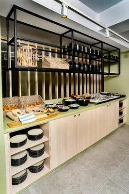 a kitchen with a counter with plates and food at Yadoya Hotel in Brussels
