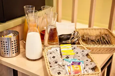 a counter with milk and baskets on a table at Yadoya Hotel in Brussels