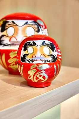 two vases with faces on them sitting on a shelf at Yadoya Hotel in Brussels