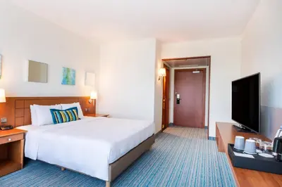 a hotel room with a bed and a flat screen tv at Courtyard By Marriott Brussels in Brussels