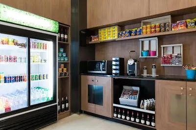 a grocery store with a counter and a refrigerator at Courtyard By Marriott Brussels in Brussels