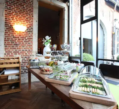 a table with a buffet of food on it at Hotel The Lodge Heverlee in Leuven