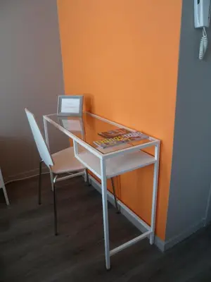 a white desk with a chair and a glass top at Suite 11 in Antwerp