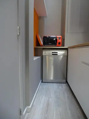 a kitchen with a dishwasher and a microwave on a counter at Suite 11 in Antwerp