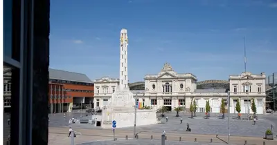 a large building with a monument in front of it at Hotel La Royale in Leuven