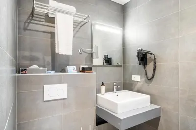 a bathroom with a white sink and a mirror at Marivaux Hotel in Brussels