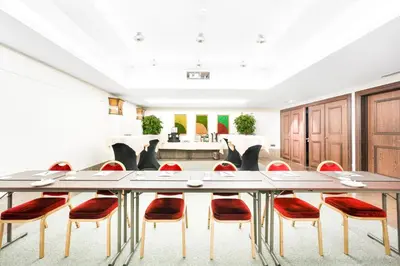 a conference room with a long table and chairs at Marivaux Hotel in Brussels