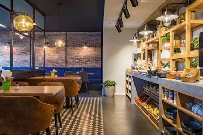 a restaurant with tables and chairs and brick walls at Park Inn By Radisson Brussels Airport in Diegem