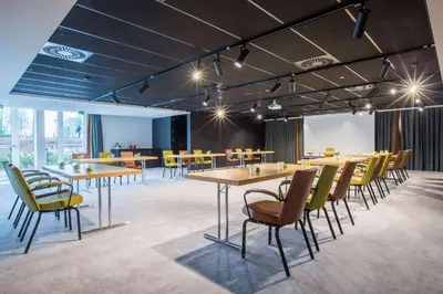 a group of tables and chairs in a room at Park Inn By Radisson Brussels Airport in Diegem
