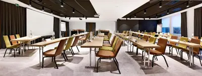 a dining room with tables and chairs and windows at Park Inn By Radisson Brussels Airport in Diegem