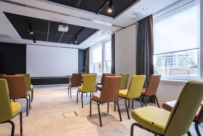a conference room with chairs and a projection screen at Park Inn By Radisson Brussels Airport in Diegem