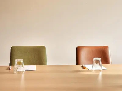 two glasses sitting on top of a wooden table at Park Inn By Radisson Brussels Airport in Diegem
