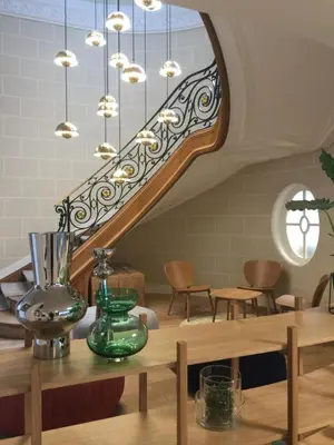 a room with a staircase with a table and chairs at Hygge Hotel in Brussels