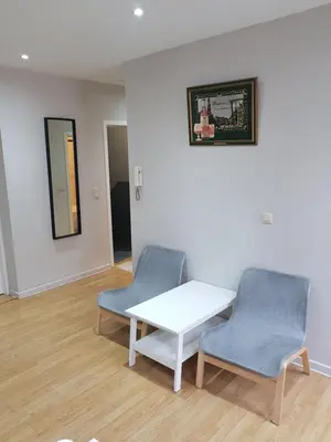 a room with two chairs and a table and a mirror at Central Yellow Apartment in Brussels