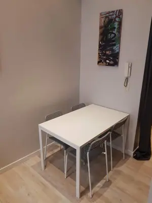 a white table with chairs in a room at Central Yellow Apartment in Brussels
