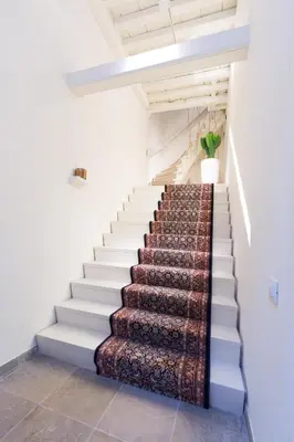 a staircase in a house with a rug on the stairs at Y & L villa in Antwerp