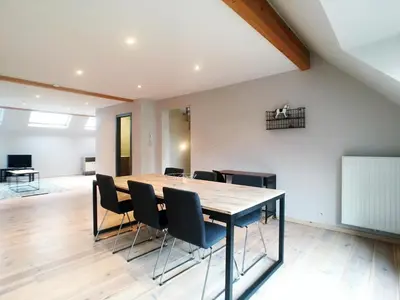 a dining room with a table and chairs at Parlamentarium apartment in Brussels