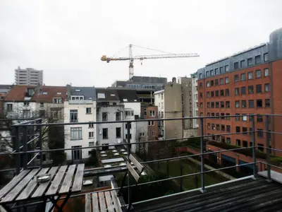 a view of a city with a crane and buildings at Parlamentarium apartment in Brussels