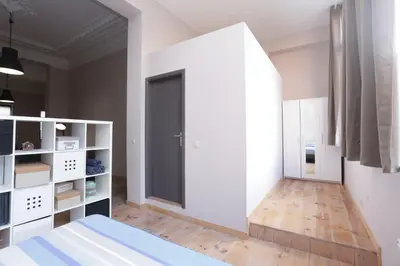 a bedroom with a bed and a large window at Parlamentarium apartment in Brussels