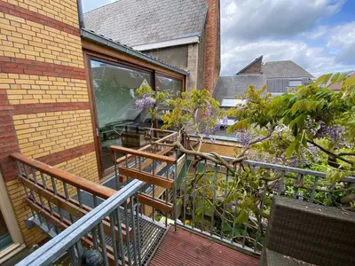 a balcony of a house with a tree on it at Lunatree in Mechelen