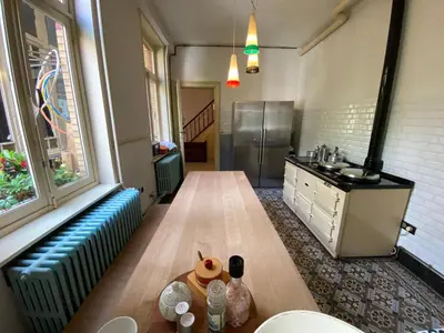 a kitchen with a table with food on it at Lunatree in Mechelen